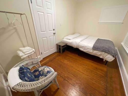 a small room with a bed and a chair at Entire Beautiful 2BR Apartment [L]. Convenient location in the heart of Queens! in Whitestone
