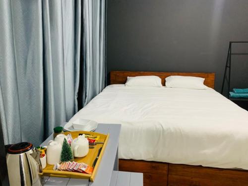 a bedroom with a bed and a tray of food at AfrikaWisa at O.R. Tambo International Airport in Kempton Park