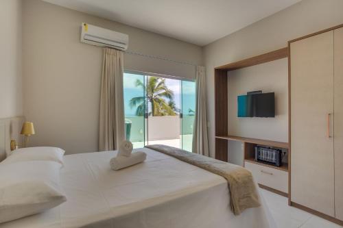 Tempat tidur dalam kamar di Kalug - Mansão de Luxo com Vista Mar na Praia do Milionários