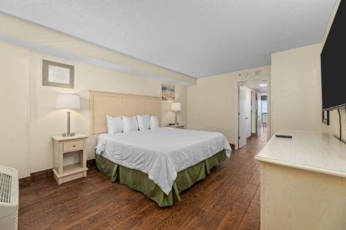 a hotel room with a large bed and a television at Oceanfront 1BR, Downtown, 4ppl in Myrtle Beach