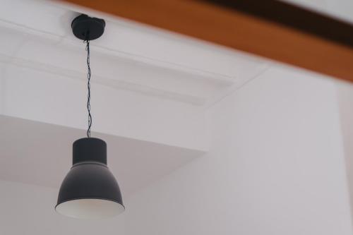 a black light fixture hanging from a ceiling at Casa Palacio -Sanlúcar- in Sanlúcar de Barrameda