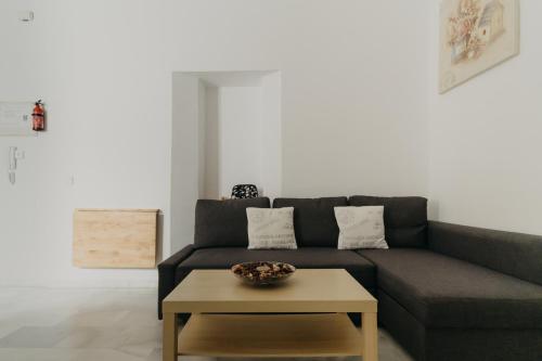 a living room with a couch and a coffee table at Casa Palacio -Sanlúcar- in Sanlúcar de Barrameda