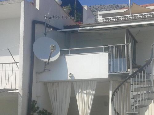 a balcony with a sign on the side of a building at Apartments Toma Bajnice Directly in Krilo