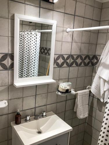 a bathroom with a sink and a mirror at SOL Y SIERRAS in Mina Clavero