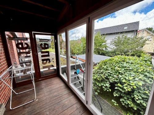 a screened in porch with a view of a balcony at OhPardon! GAILDORF - Monteurwohnung im EG, Einzelbetten, Loggia & Garten in Gaildorf