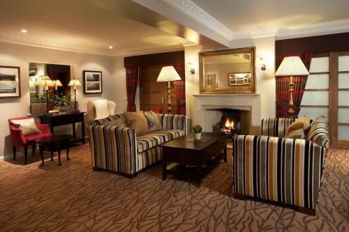 a living room with two couches and a fireplace at Three Ways House Hotel in Chipping Campden