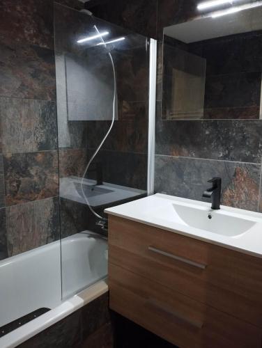 une salle de bain avec un lavabo, une baignoire et une douche dans l'établissement Studio porte du Mont Blanc Combloux aux pieds des pistes, à Combloux