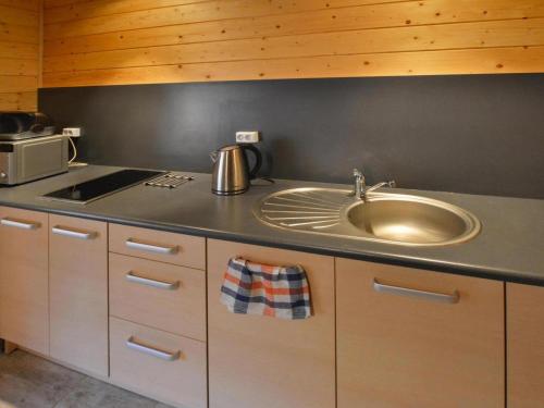 a kitchen with a sink and a stove at Holiday houses close to the beach, Siano ty in Sianozety