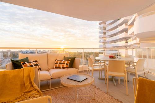a living room with a couch and a table at Gran Canet 2BR! Walk to Beach, Sea View, Sauna & Gym in Canet de Berenguer