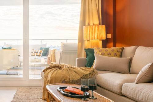 a living room with a couch and a table at Gran Canet 2BR! Walk to Beach, Sea View, Sauna & Gym in Canet de Berenguer