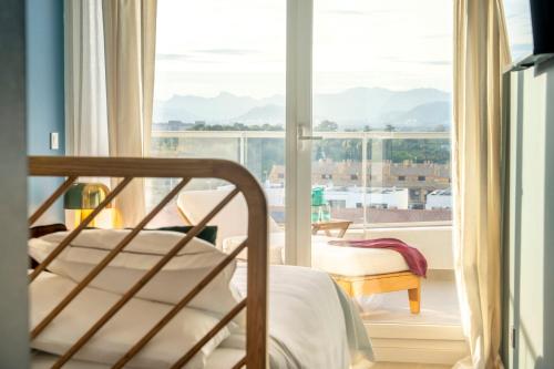 a bedroom with a bed and a large window at Gran Canet 2BR! Walk to Beach, Sea View, Sauna & Gym in Canet de Berenguer
