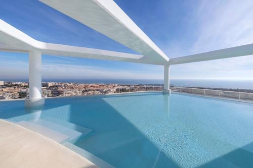 a swimming pool on the roof of a building at Gran Canet 2BR! Walk to Beach, Sea View, Sauna & Gym in Canet de Berenguer