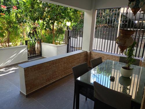 a balcony with a glass table and a fence at Cocomelo Apts in Heraklio Town