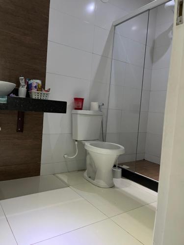 a bathroom with a toilet and a glass shower at Quarto luxo barra da Tijuca in Rio de Janeiro