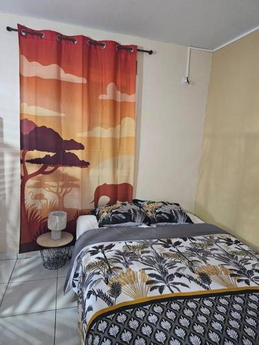 - une chambre avec un lit avec un rideau et une table dans l'établissement Chez Nana, à Cayenne