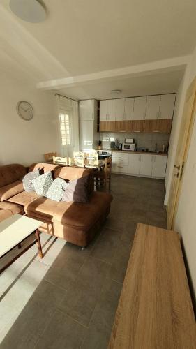 a living room with a couch and a kitchen at Deutsche Willa in Sutomore