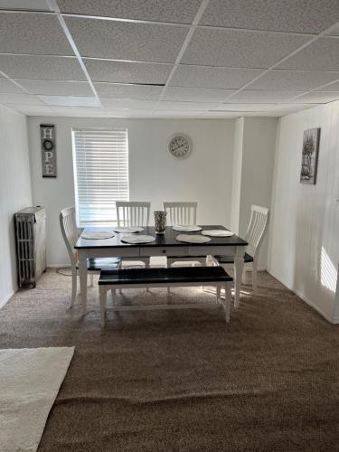 a dining room with a table and two chairs at Cozy 2 Bedroom Apt in Scranton