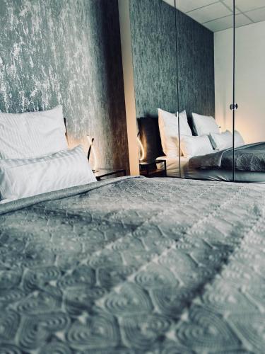 a bedroom with a large bed and a mirror at Firstclass Event & Hotel in Fürth