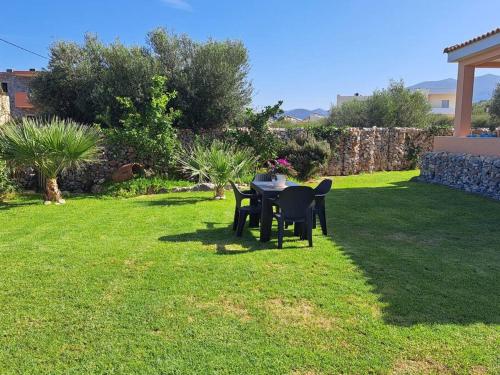 a table and chairs sitting on a lawn in a yard at Villa Christina in Malia