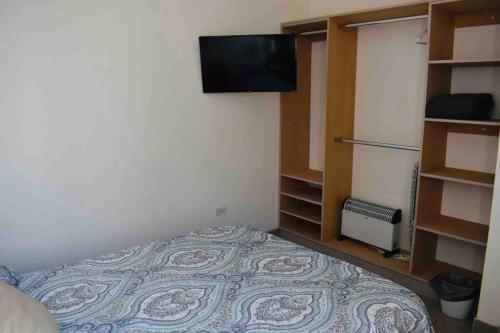a bedroom with a bed and a tv on the wall at Gabby’s Accesible House in Private area in Mexicali