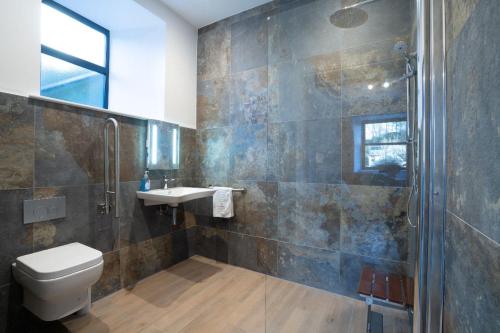 a bathroom with a toilet and a sink and a shower at New 4 Bedroom Home at Waterhead Range by LetMeStay in Ambleside