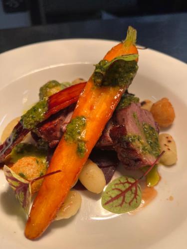 a white plate of food with carrots on it at The Old Manor House Hotel in Keynsham