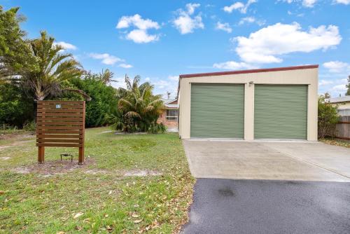 a garage with a sign in front of a house at Beach Dreams Hat Head - No Sheets or Towels provided in Hat Head