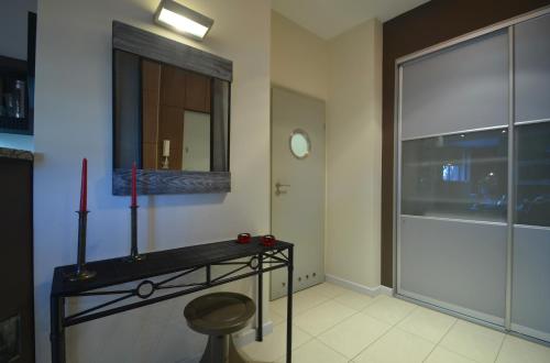 a room with a table with a candle and a window at -- Manhattan -- CENTRUM -- STARÓWKA -- in Kołobrzeg