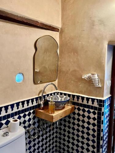 a bathroom with a sink and a mirror at DAR Naima in Fez