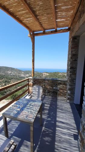 a patio with a table and a view of the ocean at Monopati Eco Villas in Raches