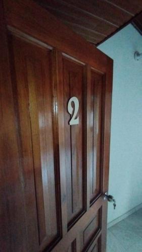 a wooden door with the number two on it at Mammamia CasaHotel in Duitama