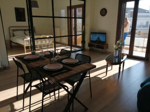 a dining table and chairs in a living room at Eleana in Ioannina