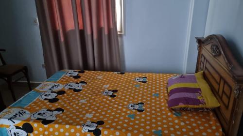 a bed with hello kittyideredpillows on it at Gardenia City cairo airport in Cairo