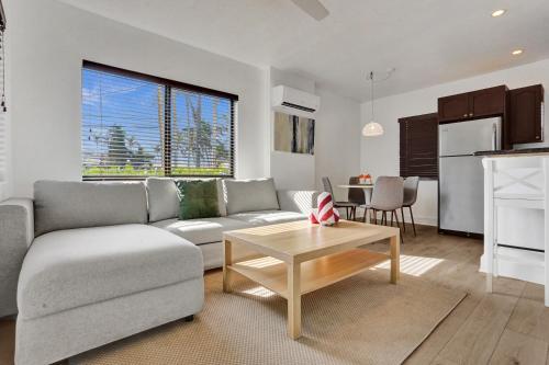a living room with a couch and a table at Waves On Walnut - Beach Access in Hollywood