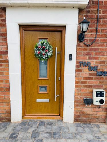 a wooden door with a wreath on it at Cannock Chase Guest House Self Catering incl all home amenities & private entrance in Cannock
