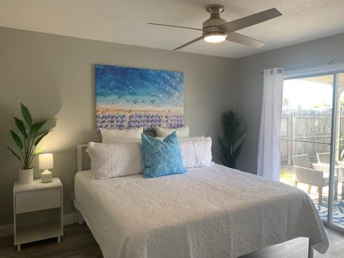 a bedroom with a bed with a ceiling fan at Tropical Haven in Panama City Beach