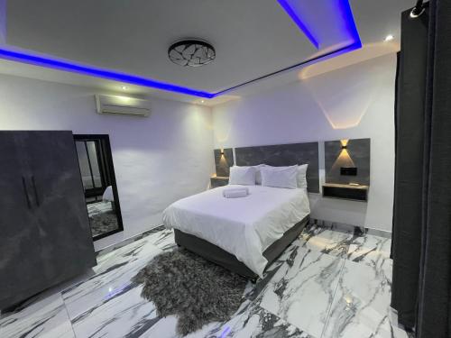a bedroom with a bed with a marble floor at Rabi’s guesthouse in Mahikeng