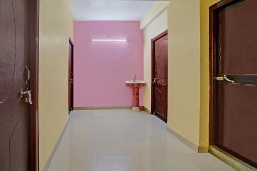 a hallway with a sink and two doors at OYO Flagship Welcome 24x7 in Patna