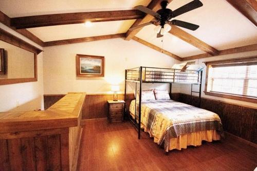 a bedroom with a bed and a ceiling fan at Lake Texoma's Barn-dominum in Pottsboro in Pottsboro
