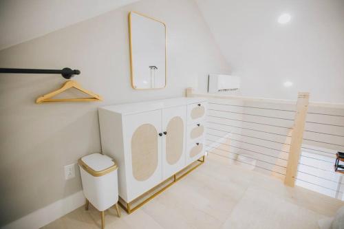 a white bathroom with a sink and a mirror at Villa Costello, in Kingston