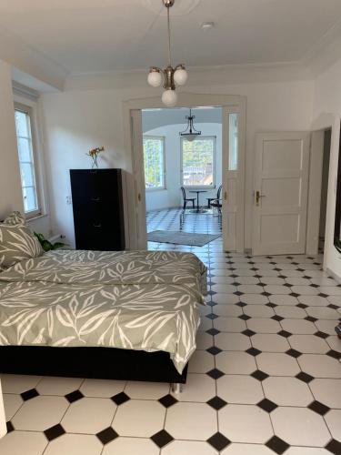 a bedroom with a bed and a black and white tiled floor at Ferienwohnung Auszeit in Boppard