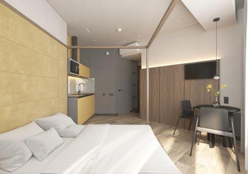 a bedroom with a bed and a table and a kitchen at FULL HOUSE apart hotel in Rivne