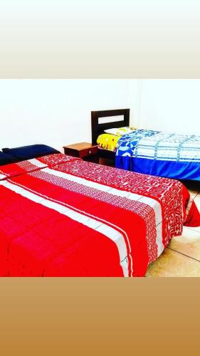 En eller flere senge i et værelse på HOSTERIA LA COSTANERA