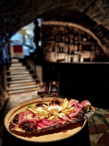 a plate of food with two glasses of wine at Hotel America in Locarno