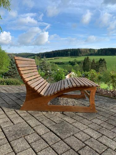 a wooden bench sitting on top of a roof at Eifler - Sonnenfels in Gerolstein