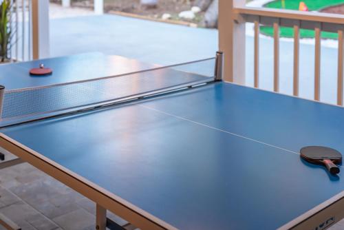 a ping pong table with a pair of scissors on it at Beautiful Texas Ranch House, Game Room & Minigolf in San Antonio