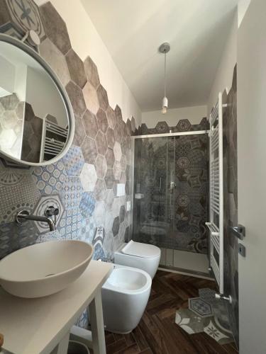 a bathroom with a sink and a toilet and a mirror at Casa Del Caval Bianco in Venaria Reale