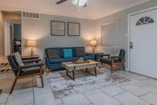 a living room with a blue couch and chairs at Beautiful Apartment at The Botanical Gardens #1 in San Antonio