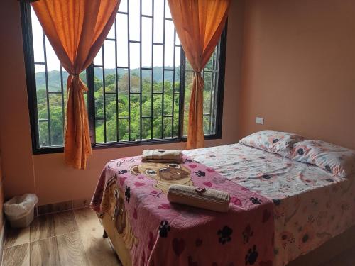 Ένα ή περισσότερα κρεβάτια σε δωμάτιο στο ApartaHotel El Balcón del Tolima