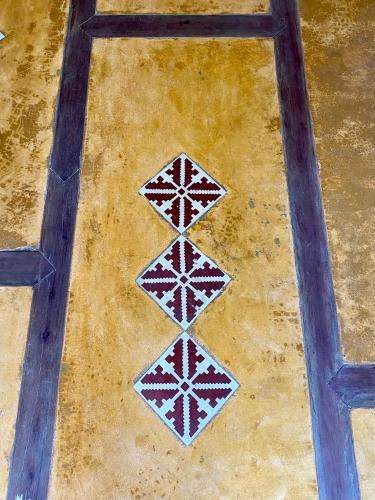 a group of four tiles on a floor at Tropicália Hostel e Pousada in Itacaré
